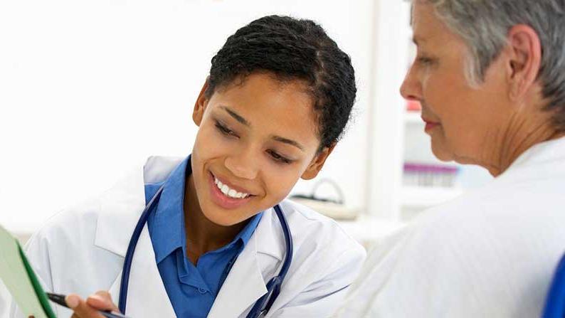 doctor showing a patient her chart