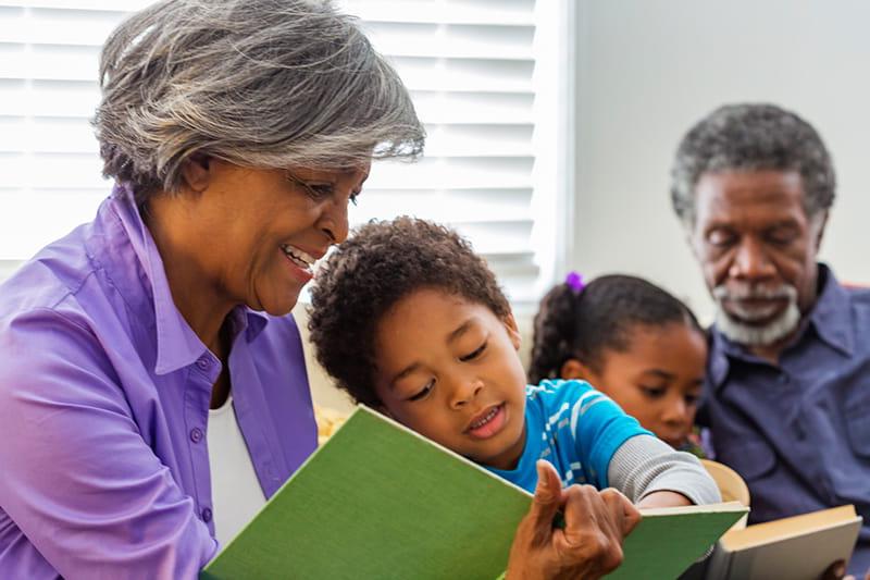 grandparents reading books to grandchildren