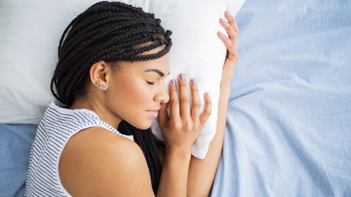 African American woman with braids sleeping